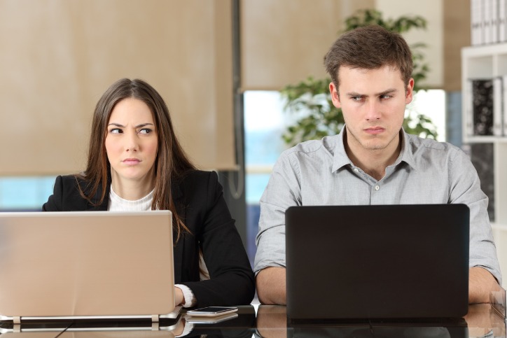 A male and female corporate employees, experiencing workplace conflict