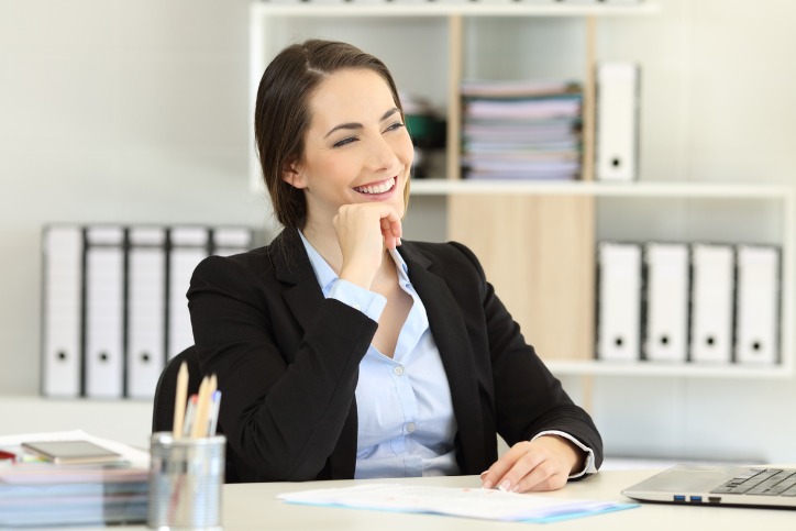 Employee retention strategies result in happy workers like this female office worker