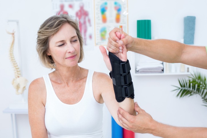 Doctor examining a female patients after a wrist injury