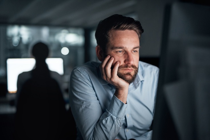 Male worker who is dealing with burnout from overworking.