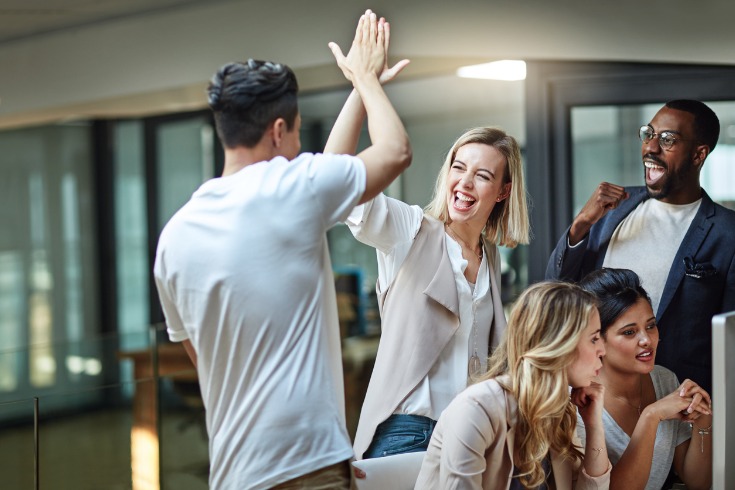 Colleagues celebrating a win while maintaining their strong working relationships with one another.