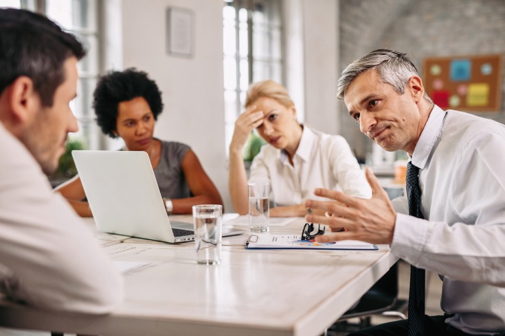 Group of office workers resolving conflict due to an argument