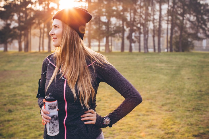 A woman staying healthy and happy this winter, taking a walk.