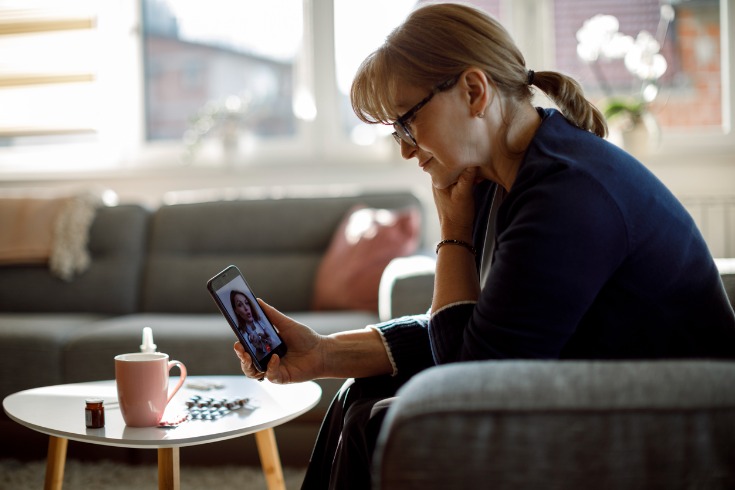 Woman discussing concerns with her doctor while attending one of her telehealth appointments.