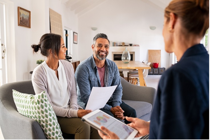 Couple speaking with a financial advisor to help curb their financial stress and boost mental health.